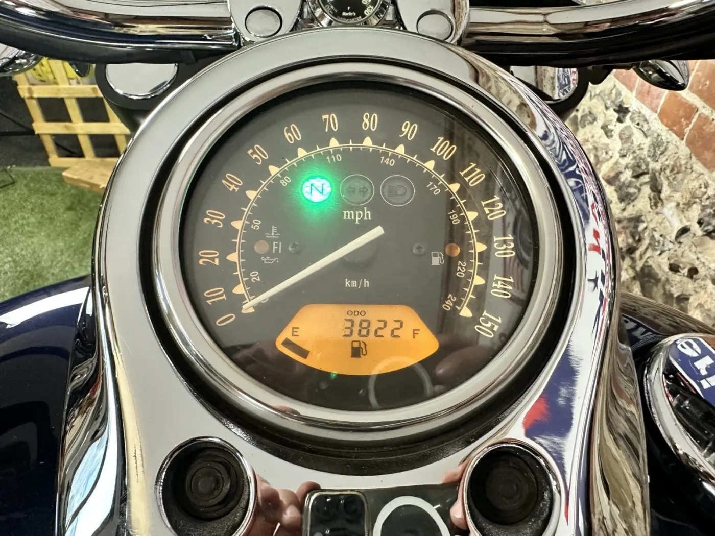 Tank-top instrument cluster — speedo, neutral light and fuel gauge