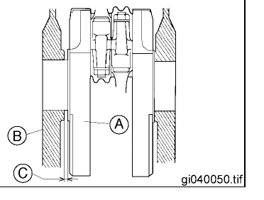 Crankshaft web between the two crankcase halves with a feeler gauge measuring the axial side clearance.