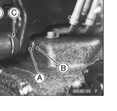 Close-up of an engine-mount adjusting bolt against the crankcase boss during installation, with callouts.