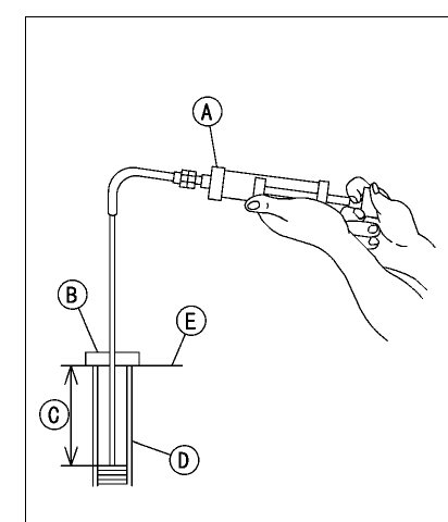 Fork oil level gauge being used to draw the oil down to the set level in the fork inner tube.