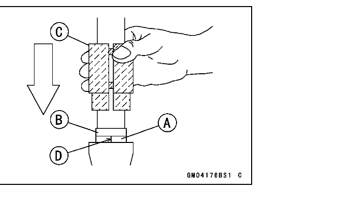 A hand tapping the fork oil seal driver down the inner tube to seat the guide bushing and oil seal into the outer tube.