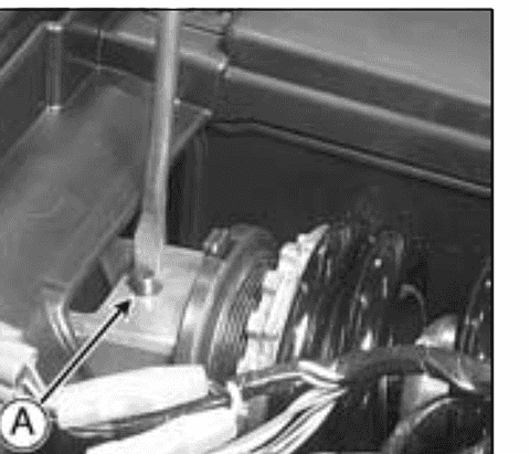 The rear shock absorber with an arrow marking the rebound damping adjuster at the foot of the unit.
